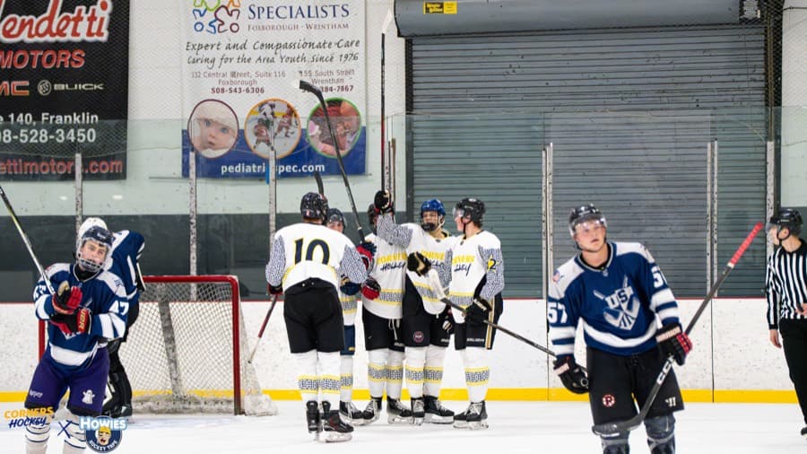 Corners Hockey players gathering at the net after a goal